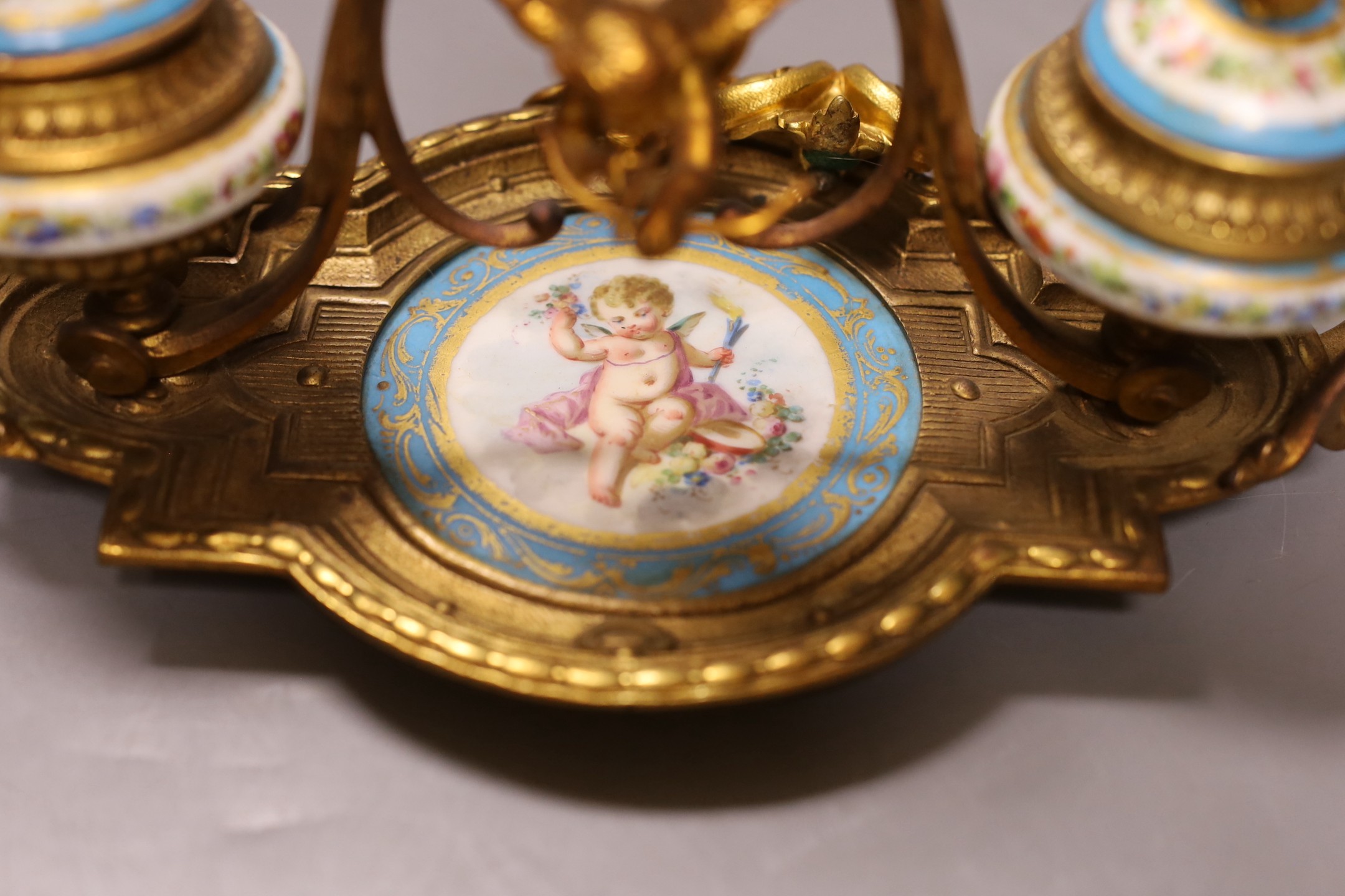 A late 19th century ormolu and 'Sevres' inkstand with cherub and floral decoration - 29cm long